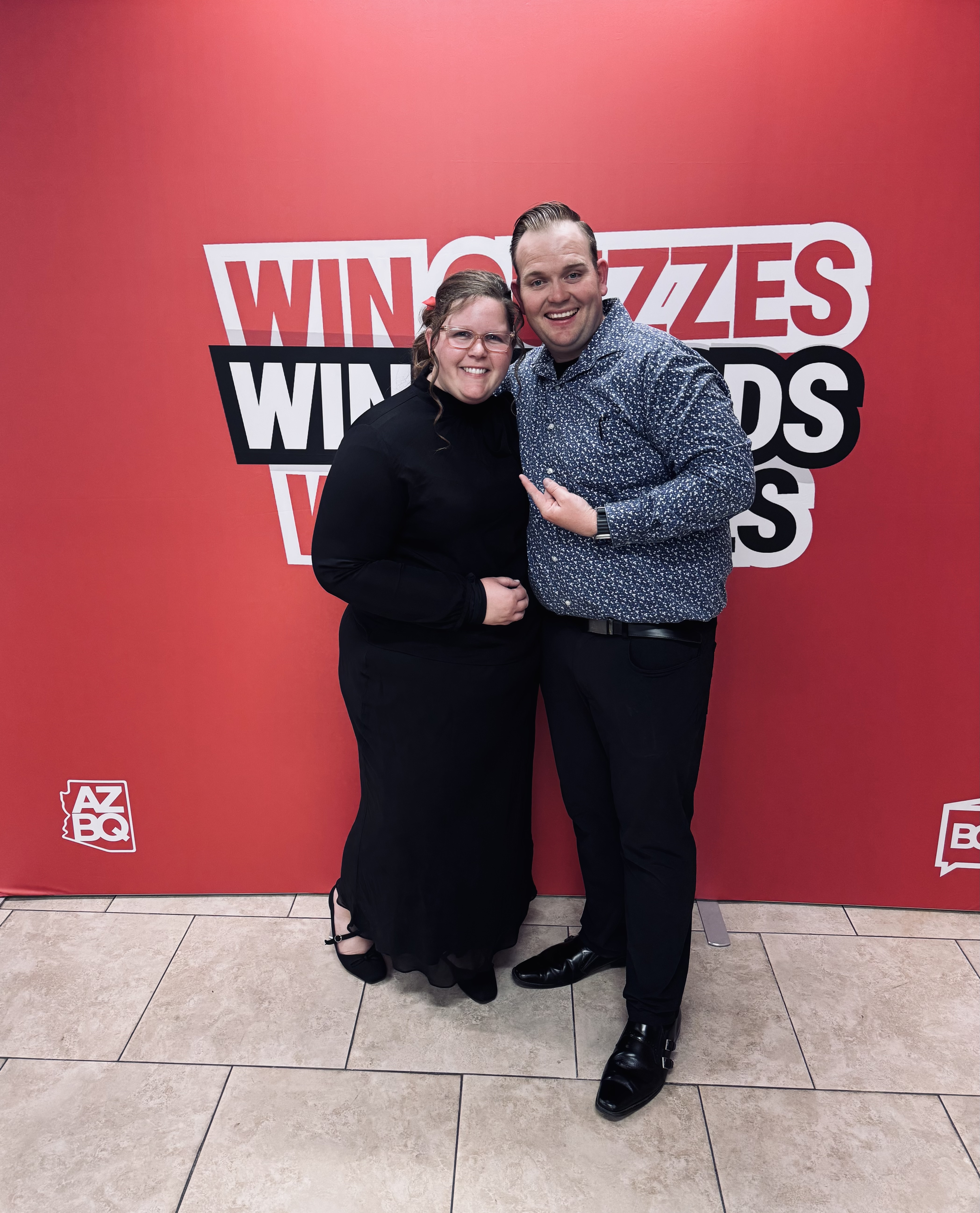 Photo of a couple in front of a red background