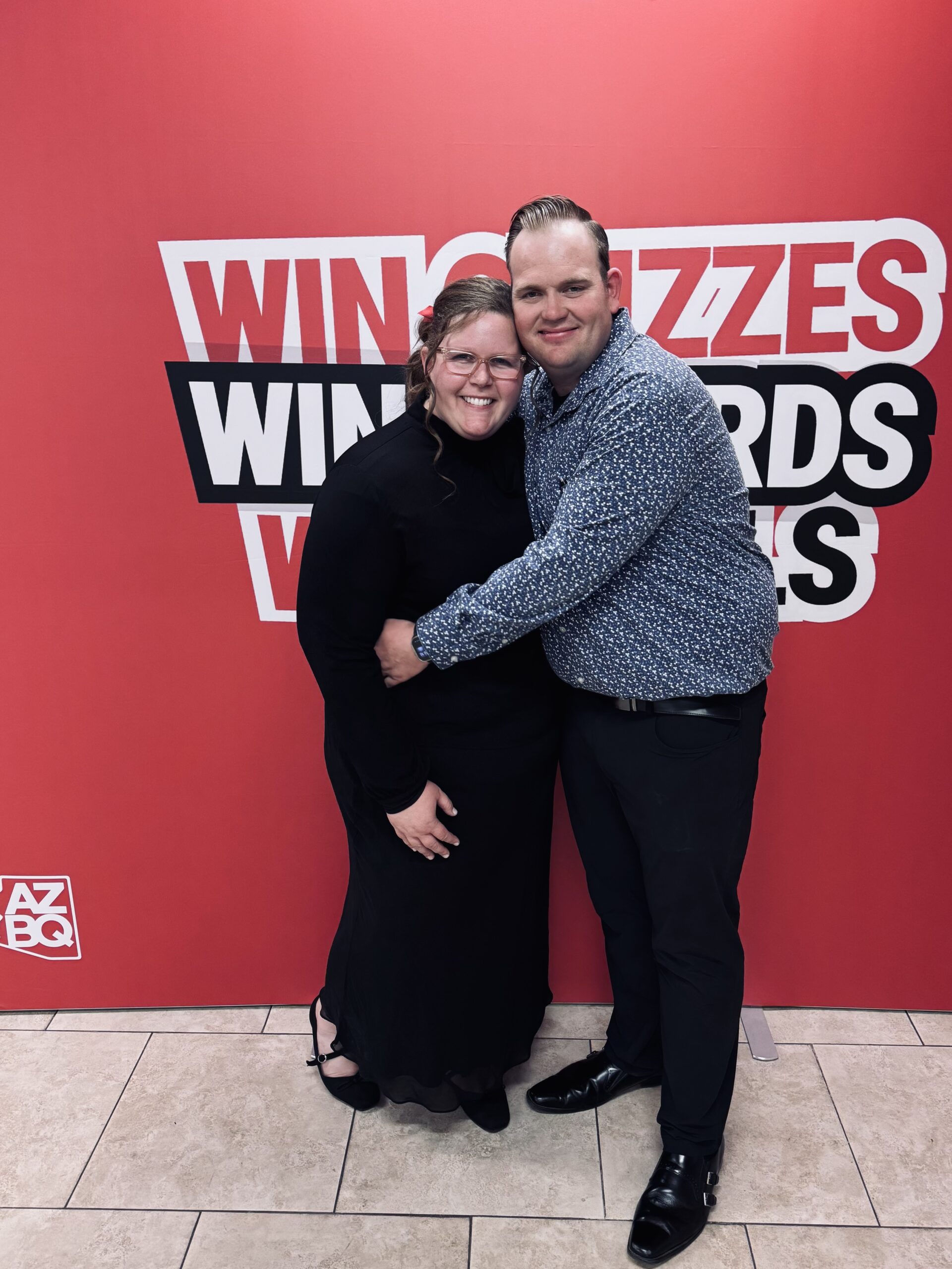 Photo of a couple in front of a red background